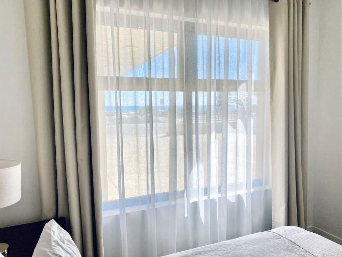 View to the ocean out of a bedroom in Atlantic West Beach Apartments